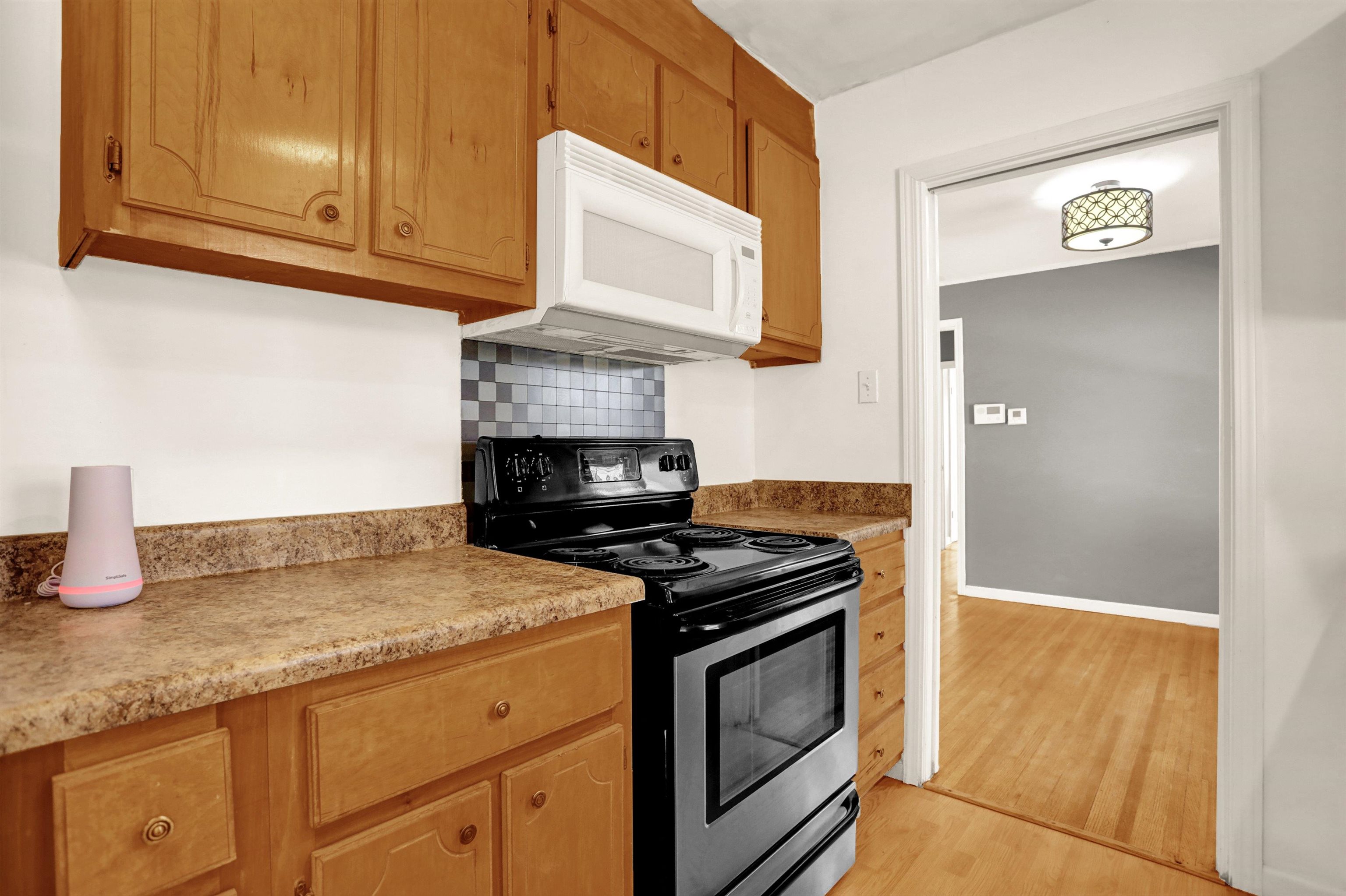 1459 Flamingo Road Memphis, TN 38117 - Photo 23 of 31 a kitchen with granite countertop cabinets and steel stainless steel appliances