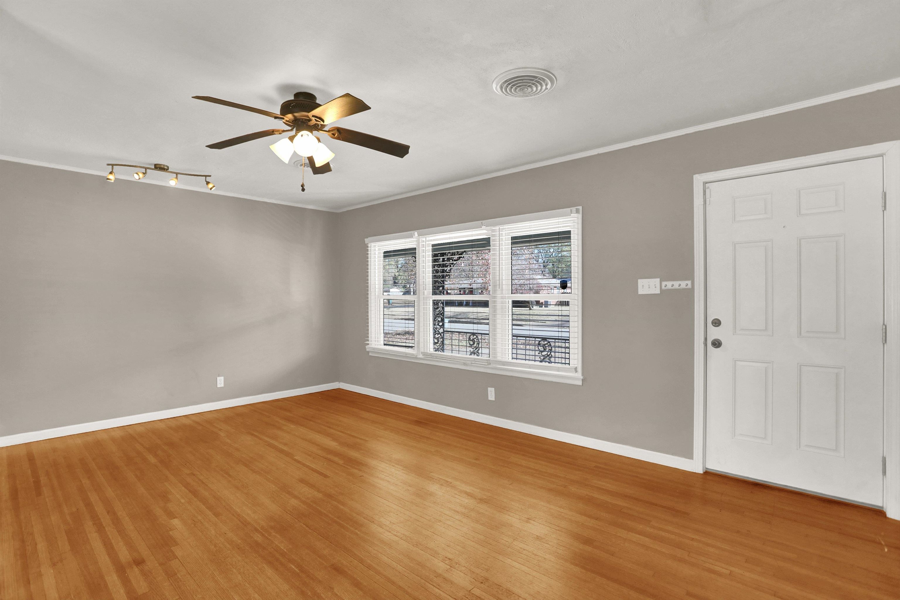 1459 Flamingo Road Memphis, TN 38117 - Photo 27 of 31 a view of an empty room with a window and wooden floor