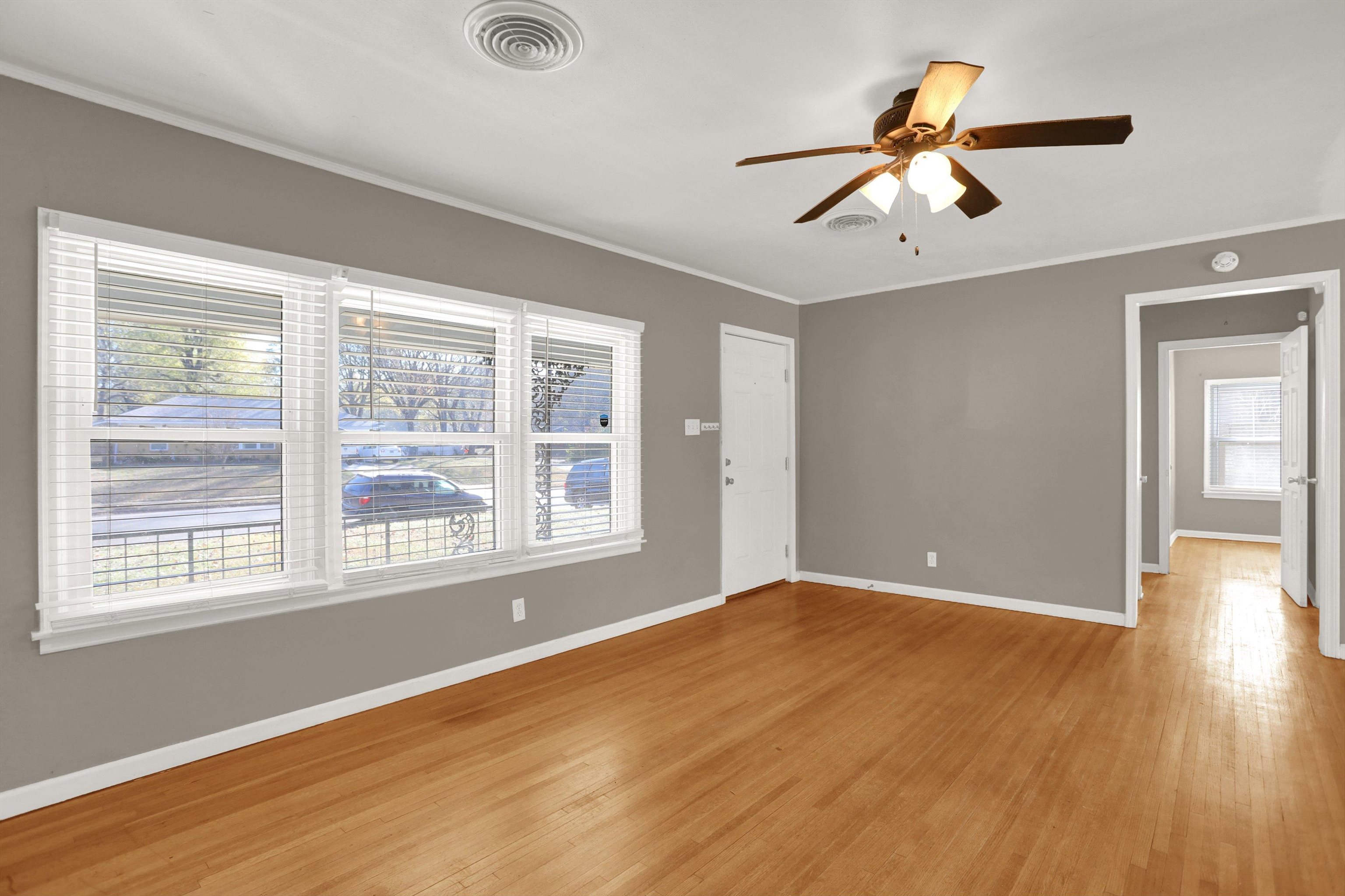 1459 Flamingo Road Memphis, TN 38117 - Photo 5 of 31 a view of an empty room with wooden floor and a window