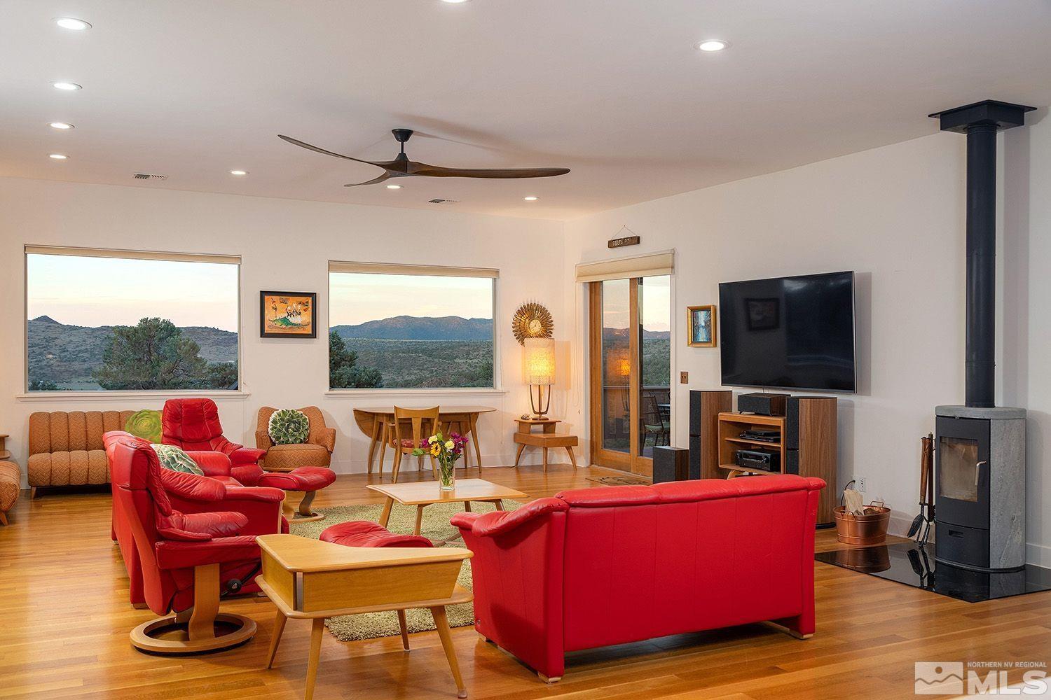 21635 Delta Drive Reno, NV 89521 - Photo 12 of 27 a living room with furniture a flat screen tv and a floor to ceiling window