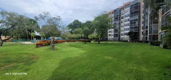 a view of a kids park with a building in the background