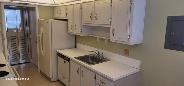 a kitchen with stainless steel appliances granite countertop a refrigerator and a sink