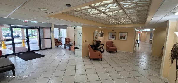 a lobby with furniture and a chandelier