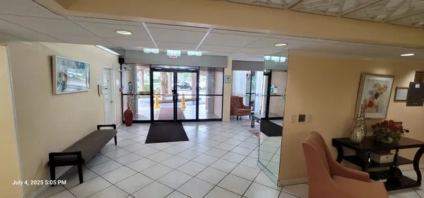 a lobby with furniture and window