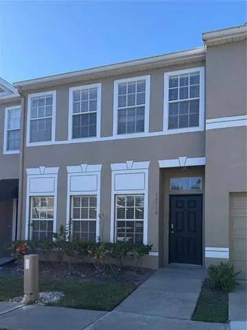 a front view of residential houses with yard