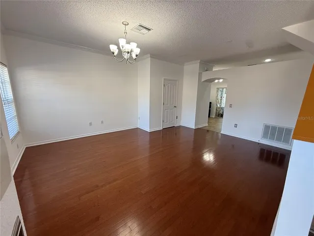a view of an empty room with a chandelier