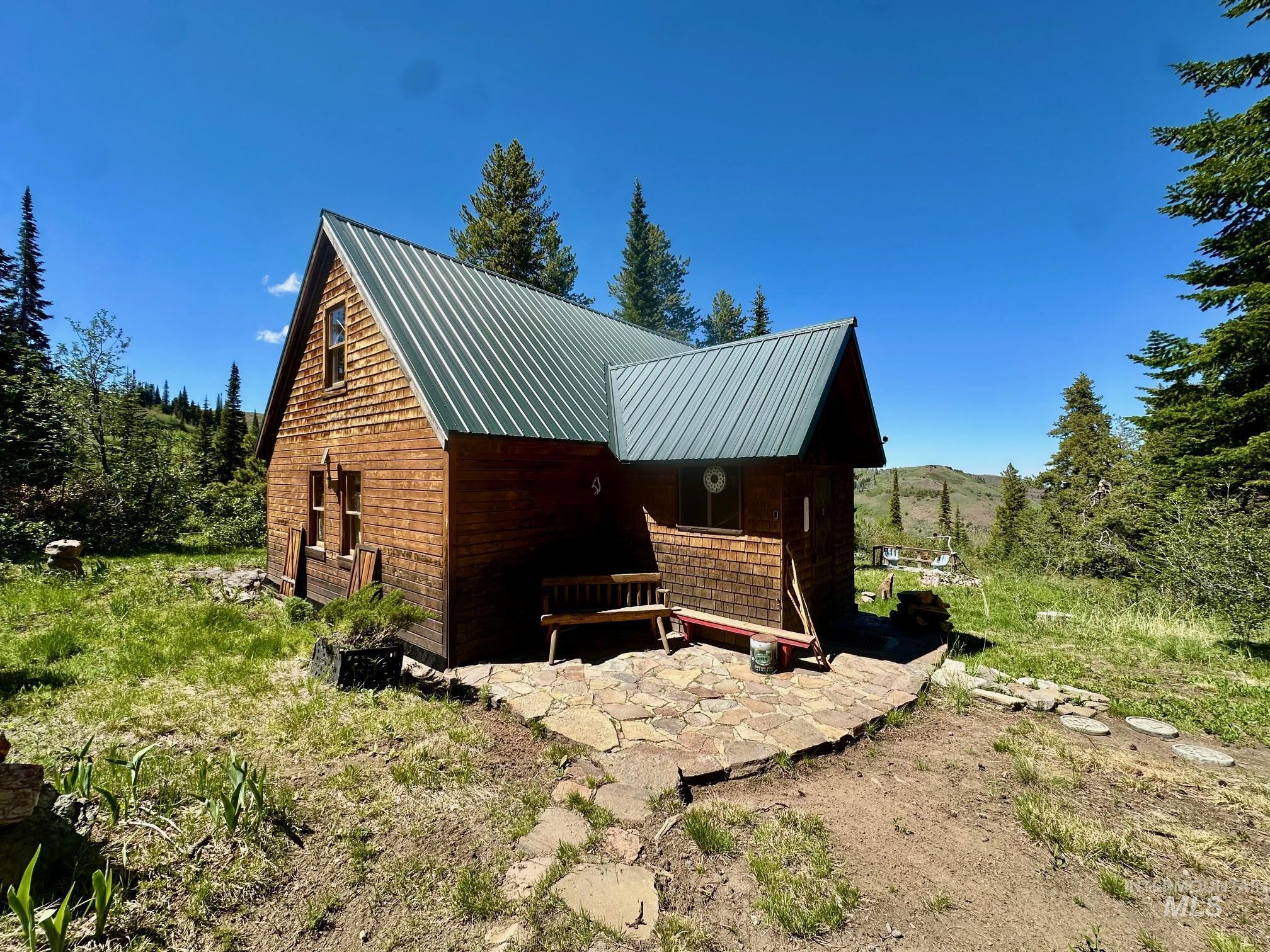 509 Deadline Road, Unit 2 Twin Falls, ID 83301 - Photo 4 of 28 Rustic cabin exterior featuring wood siding and a green metal roof