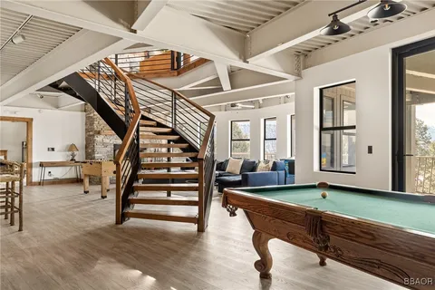 a living room with furniture and wooden floors