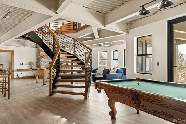 a living room with furniture and wooden floors