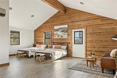 a bedroom with a bed wooden floor and lamp