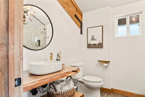a bathroom with a toilet sink and mirror