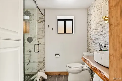 a bathroom with a toilet and shower