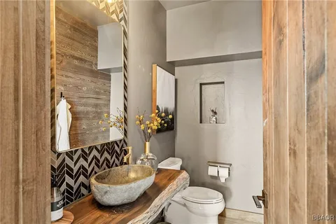 a bathroom with a toilet a sink and mirror