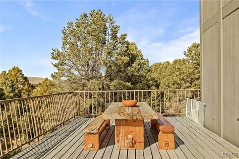 a view of balcony with wooden floor and fence