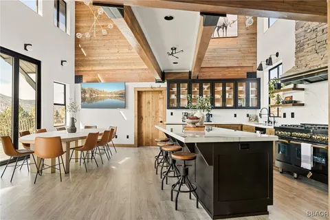a view of a dining room with furniture and chandelier