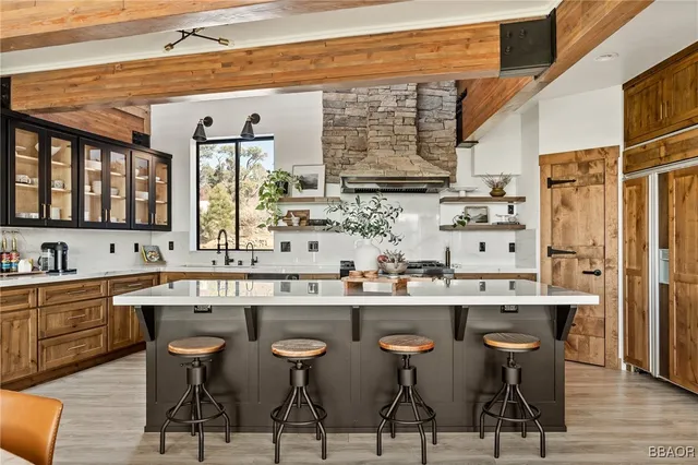 a kitchen with stainless steel appliances a sink stove and wooden cabinets