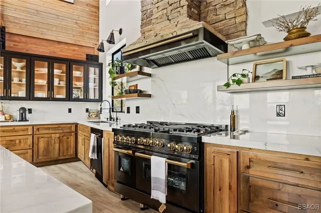a kitchen with stainless steel appliances granite countertop a stove and a sink