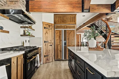 a kitchen with stainless steel appliances granite countertop a stove and a sink