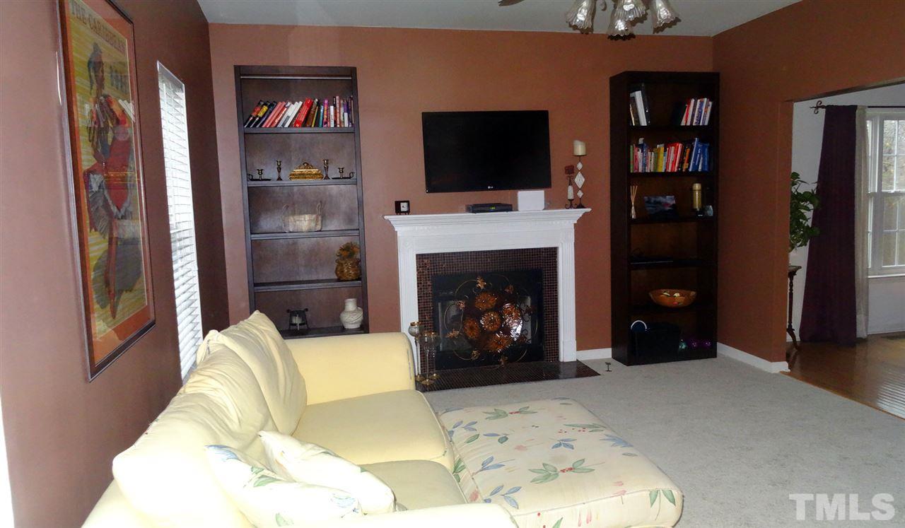 7908 Old Mill Ridge Court Raleigh, NC 27616 - Photo 2 of 17 a living room with furniture and a fireplace