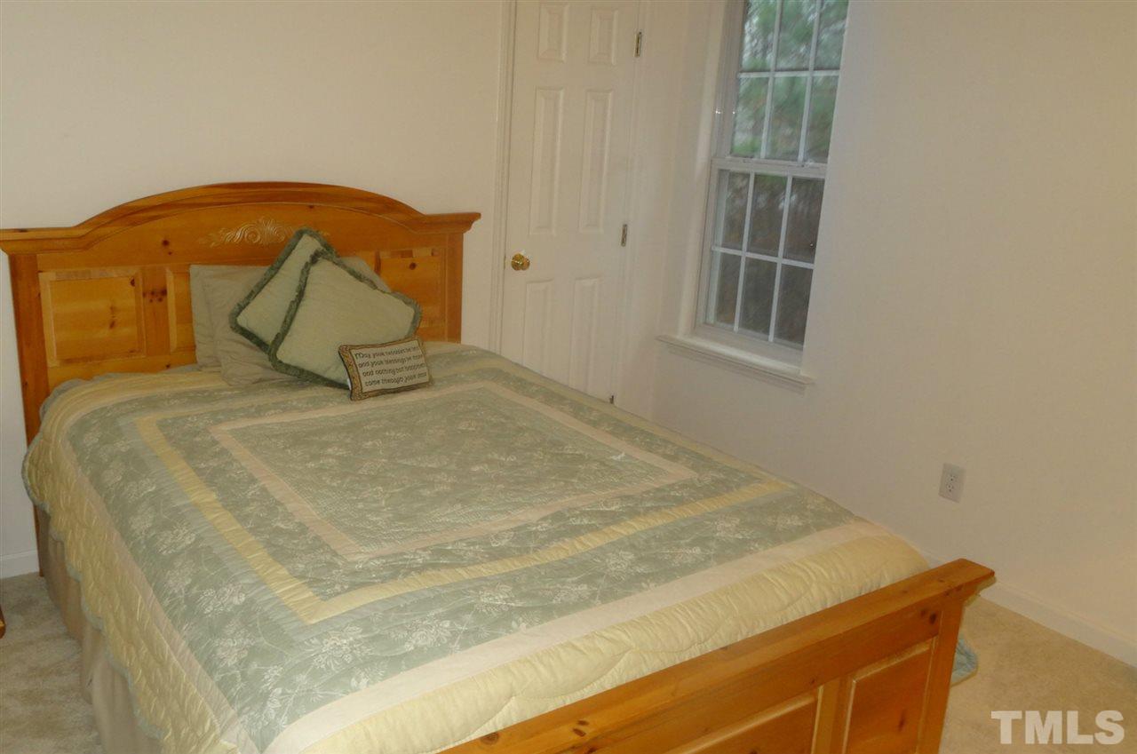 7908 Old Mill Ridge Court Raleigh, NC 27616 - Photo 11 of 17 a bed sitting in a bedroom next to a window