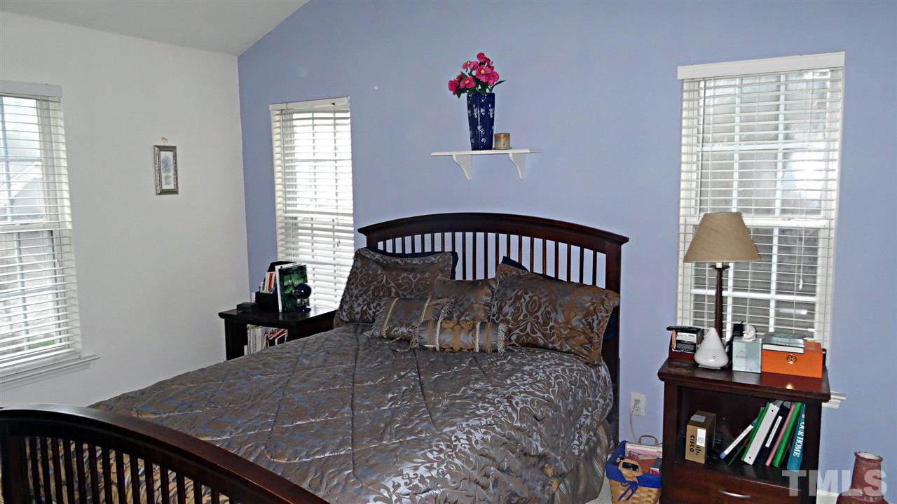 7908 Old Mill Ridge Court Raleigh, NC 27616 - Photo 13 of 17 a bed sitting in a bedroom next to a window