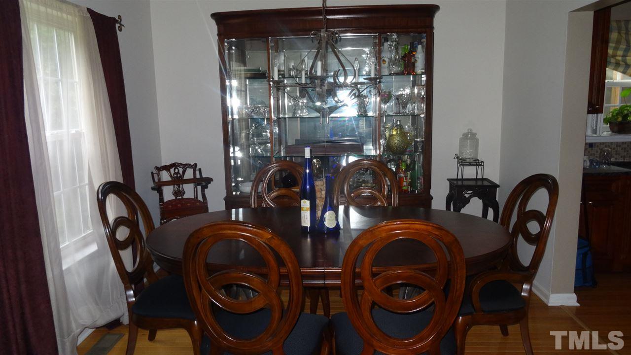 7908 Old Mill Ridge Court Raleigh, NC 27616 - Photo 5 of 17 a dining room with furniture and chandelier
