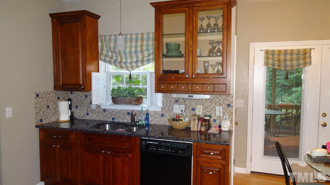 7908 Old Mill Ridge Court Raleigh, NC 27616 - Photo 6 of 17 a kitchen with stainless steel appliances a sink and a window