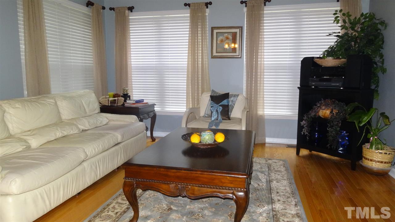 7908 Old Mill Ridge Court Raleigh, NC 27616 - Photo 9 of 17 a living room with furniture and a potted plant