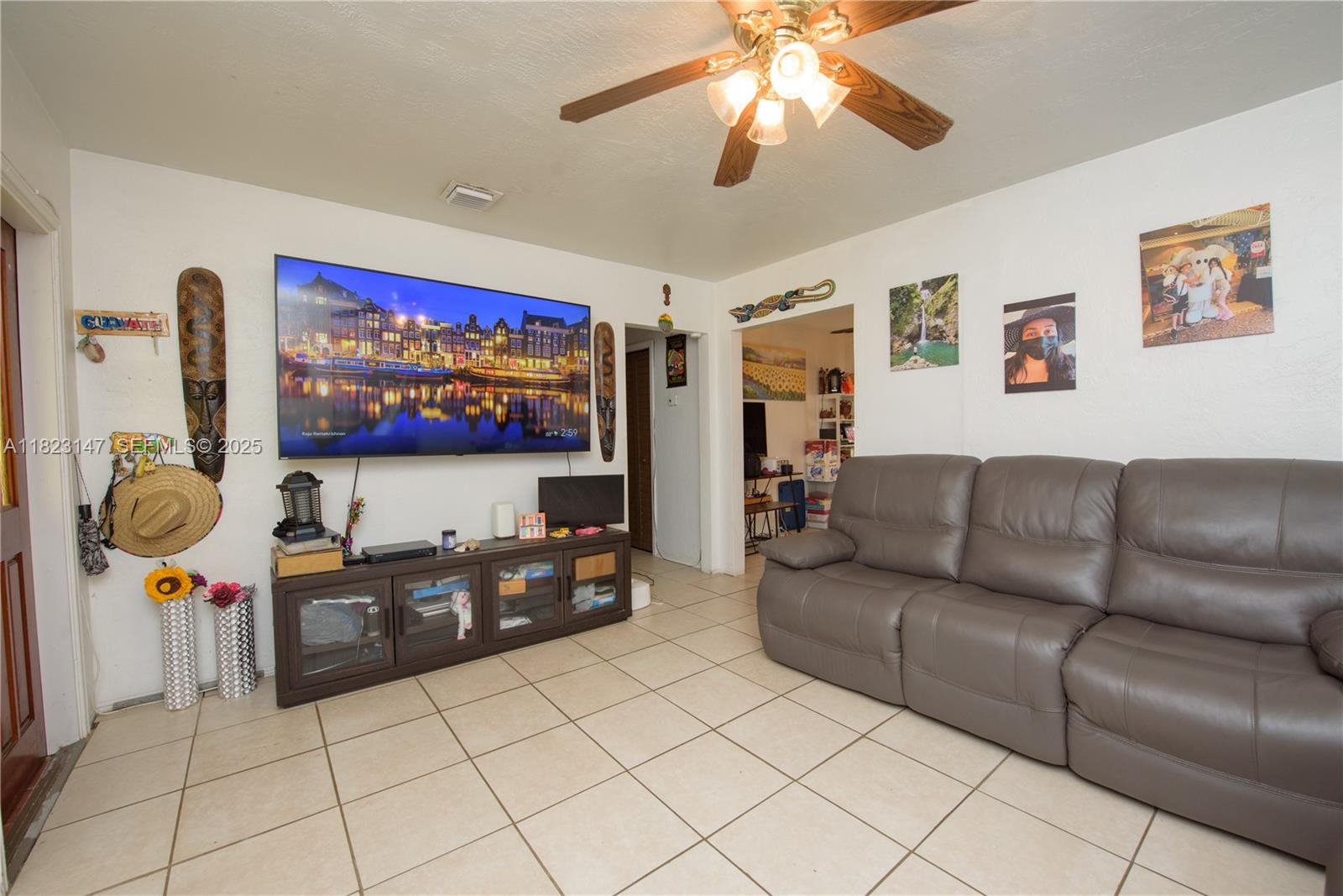 926 Northwest 3rd Avenue Homestead, FL 33030 - Photo 4 of 23 a living room with furniture and a flat screen tv
