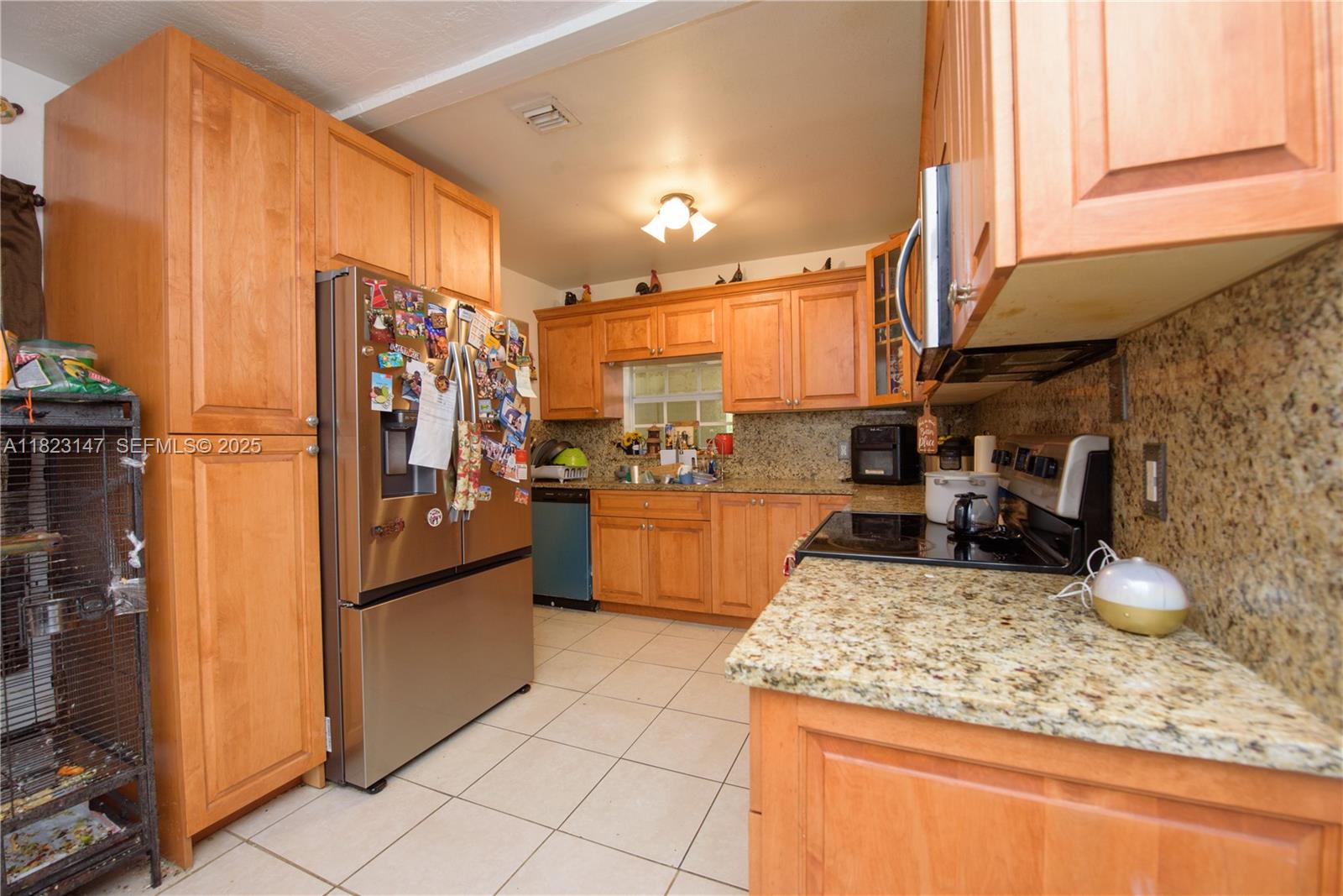 926 Northwest 3rd Avenue Homestead, FL 33030 - Photo 7 of 23 a kitchen with stainless steel appliances granite countertop a refrigerator a stove and a sink