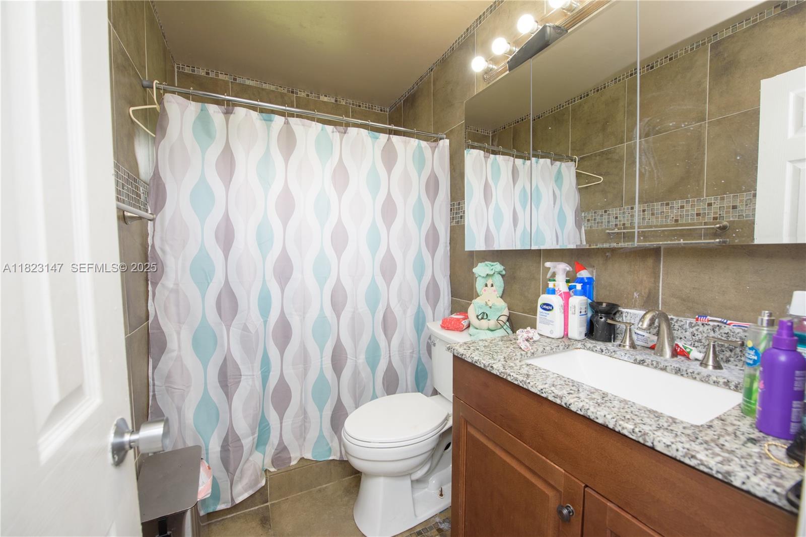 926 Northwest 3rd Avenue Homestead, FL 33030 - Photo 10 of 23 a bathroom with a granite countertop sink toilet and shower