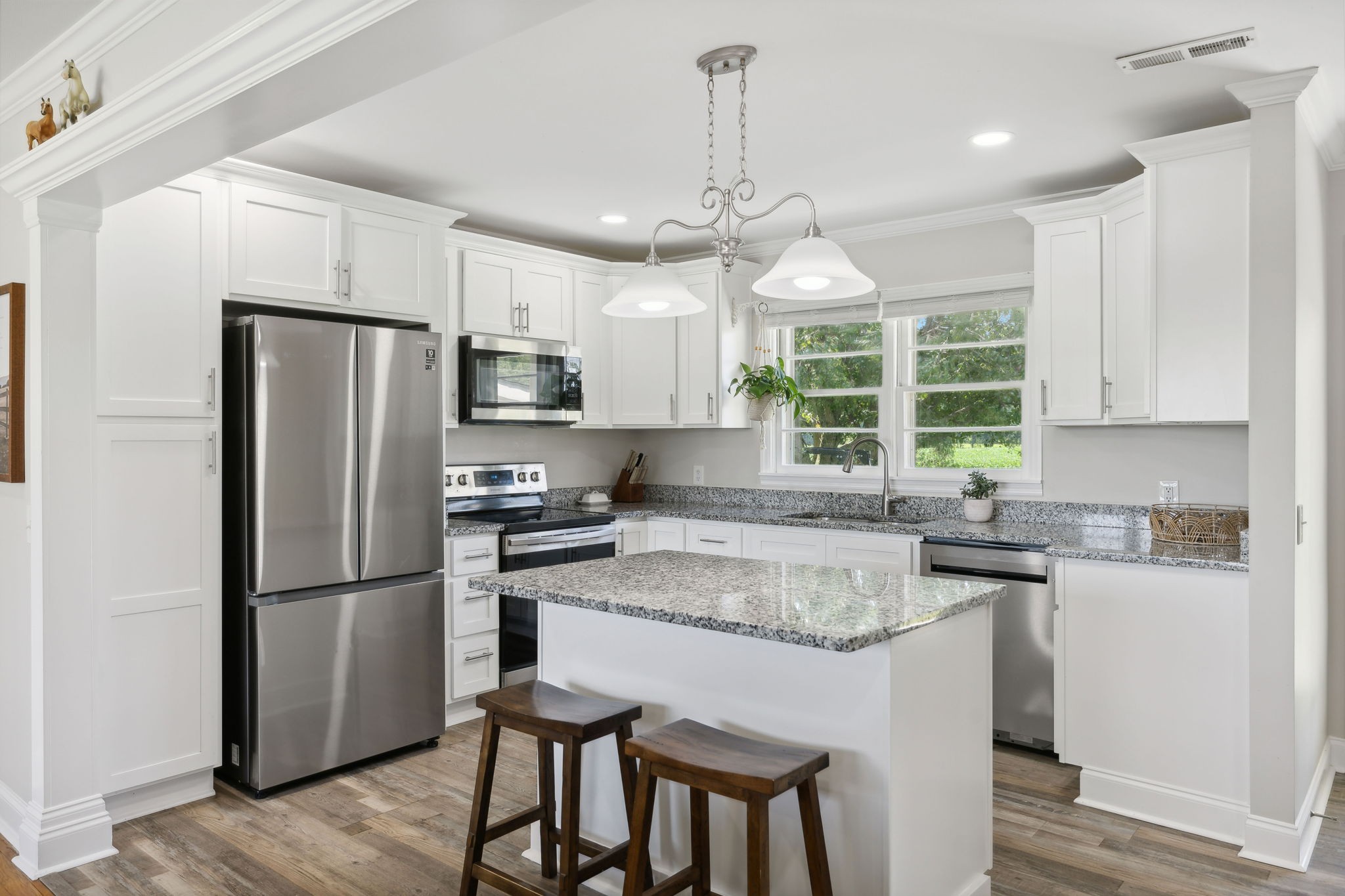 40 Yates Road Hillsboro, TN 37342 - Photo 8 of 39 a kitchen with granite countertop a refrigerator a oven a sink a center island and wooden floor