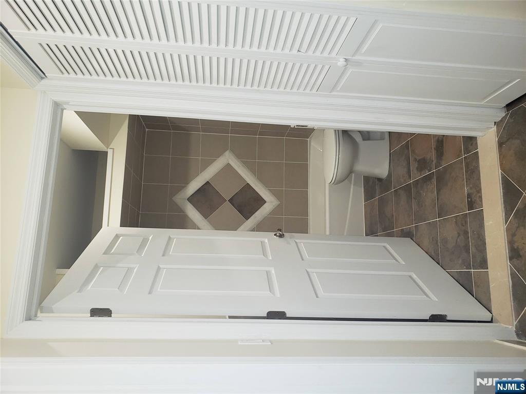 44 Bergen Boulevard, Unit 9 Fairview, NJ 07022 - Photo 11 of 16 a bathroom with a toilet and a shower