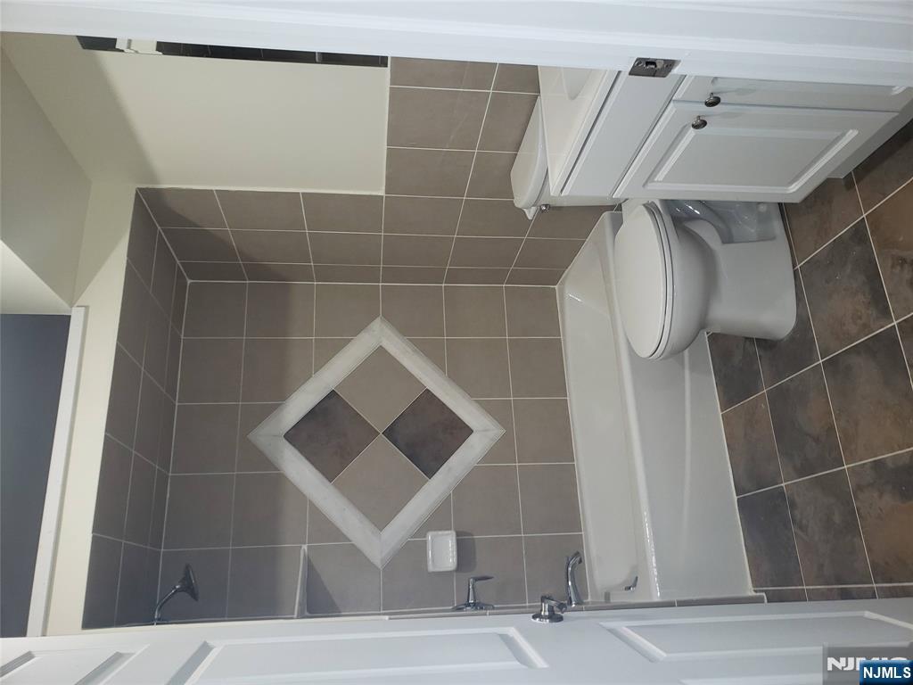 44 Bergen Boulevard, Unit 9 Fairview, NJ 07022 - Photo 12 of 16 a bathroom with a toilet and a shower