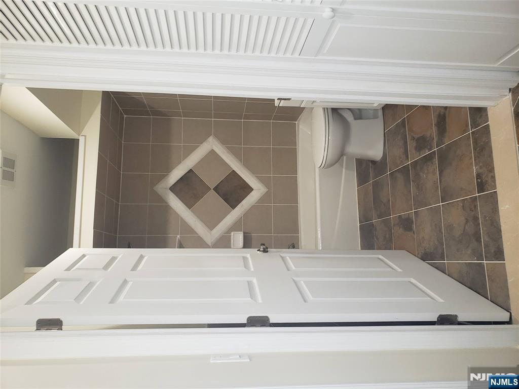 44 Bergen Boulevard, Unit 9 Fairview, NJ 07022 - Photo 13 of 16 a bathroom with a toilet and a shower