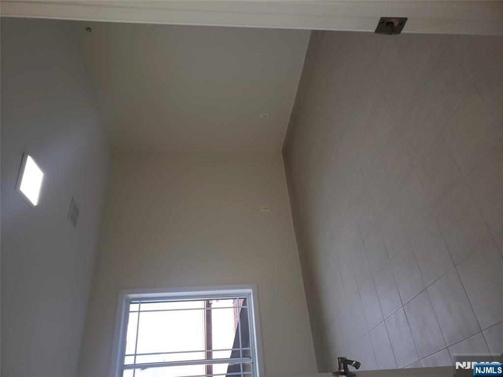 44 Bergen Boulevard, Unit 9 Fairview, NJ 07022 - Photo 14 of 16 an empty room with a window
