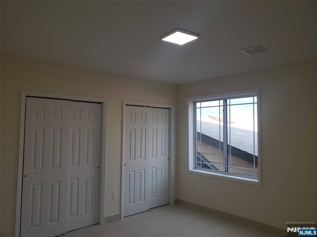 44 Bergen Boulevard, Unit 9 Fairview, NJ 07022 - Photo 15 of 16 an empty room with windows