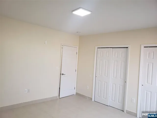an empty room with closet area