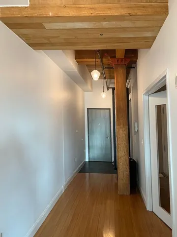 a view of hallway with wooden floor