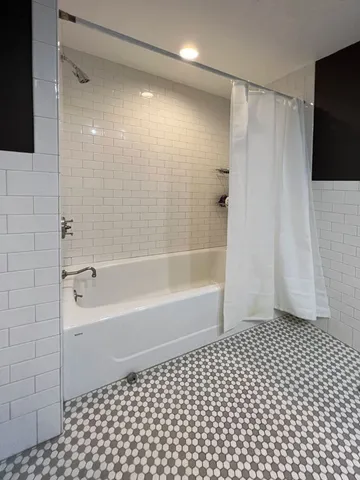 a bathroom with a bathtub and a shower