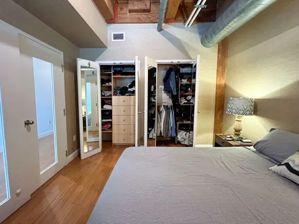a bed room with a bed and a large mirror