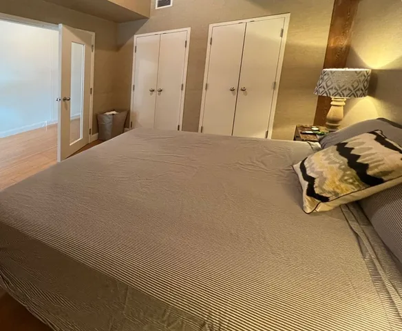 a bedroom with a bed and a mirror