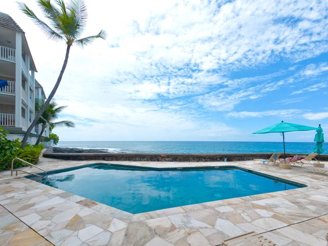 a view of swimming pool with seating space