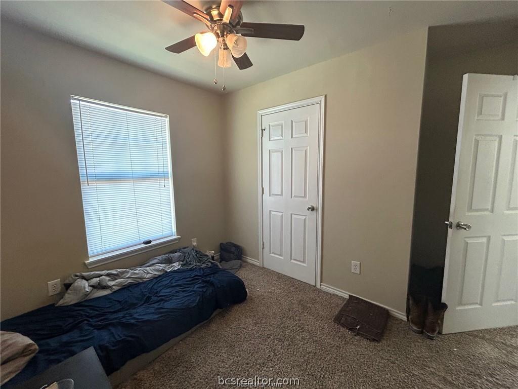 305 Ehlinger Drive, Unit D Bryan, TX 77801 - Photo 9 of 11 a bedroom with a bed and a window