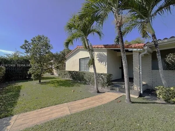 a front view of a house with garden