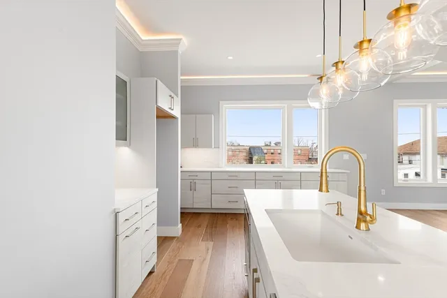 a kitchen with cabinets a sink and appliances
