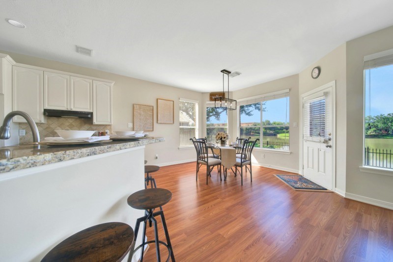 3206 Summer Bay Drive Sugar Land, TX 77478 - Photo 14 of 43 a kitchen with stainless steel appliances granite countertop a dining table chairs stove a refrigerator and cabinets