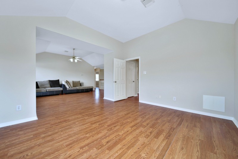 3206 Summer Bay Drive Sugar Land, TX 77478 - Photo 30 of 43 an empty room with wooden floor kitchen view and a window