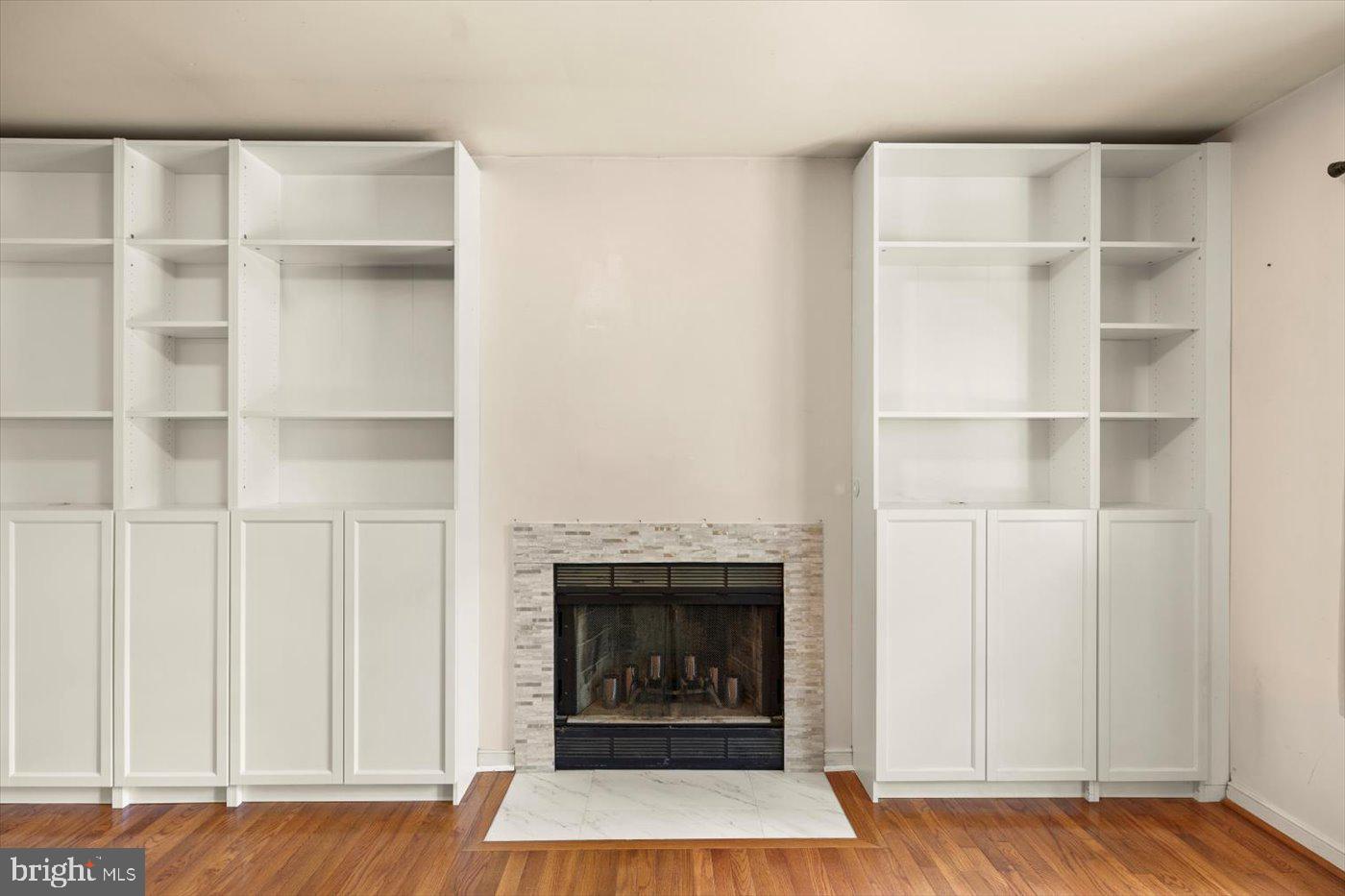 975 Swan Lane Ruther Glen, VA 22546 - Photo 11 of 42 a living room with a fireplace and a walk in closet with wooden floor