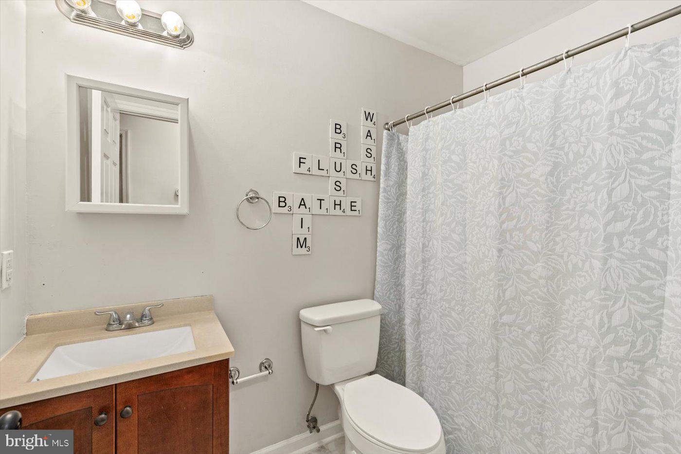 975 Swan Lane Ruther Glen, VA 22546 - Photo 17 of 42 a bathroom with a toilet sink and mirror